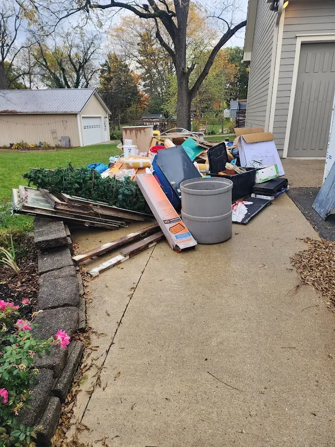 Dumpster being loaded with debris for 12 Yard Dumpster Rental in Franconia